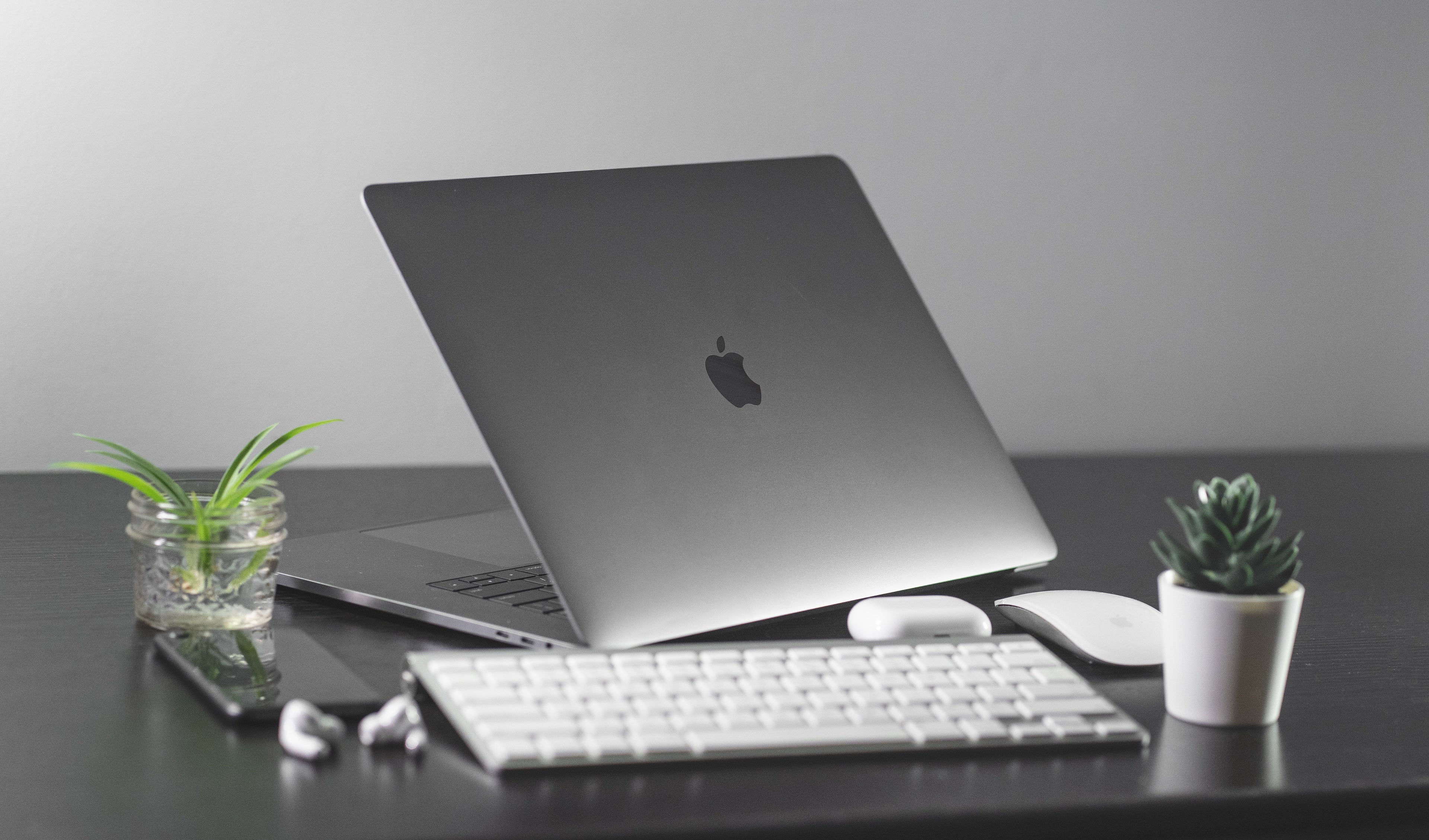 silver macbook pro laptop with wireless keyboard